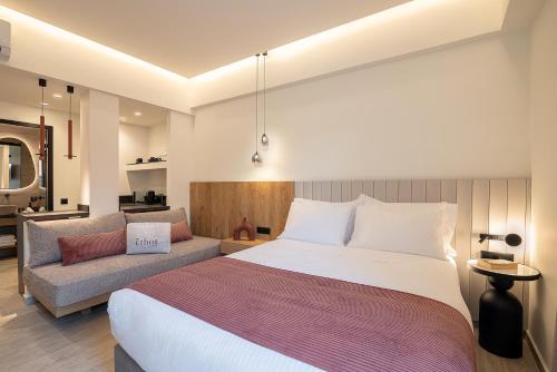 a bedroom with a large bed and a couch at Zoera Suites by Ethos in Chania
