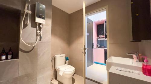 a small bathroom with a toilet and a sink at Paxtonz Suite Damansara by Light House in Kuala Lumpur