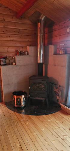 a woodburning stove in a room in a cabin at Fredbo in Melåa