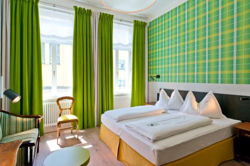 a bedroom with a large bed with green curtains at Hotel Beethoven Wien in Vienna