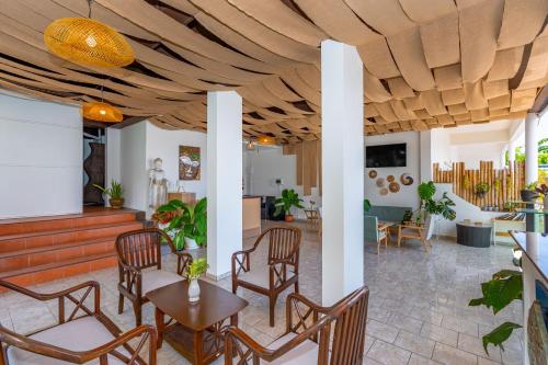 a lobby with chairs and tables and a living room at Kata Hill Sea View Hotel in Kata Beach