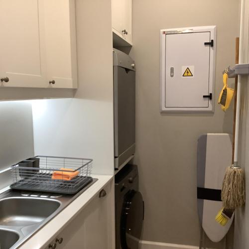 a small kitchen with a sink and a refrigerator at Apartment Franschhoek 121 Lermitage in Franschhoek