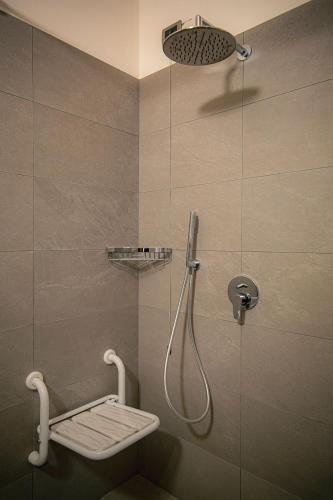 a bathroom with a shower with a shower head at Agri Alloggio Poggiolina in Bagnara di Romagna