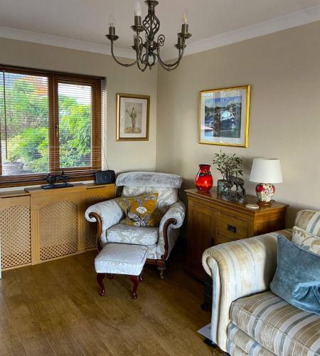 a living room with two chairs and a couch at The Mews Llantrisant in Llantrisant