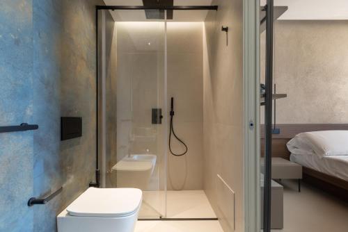 a bathroom with a shower with a toilet and a sink at Bed & Mare by Perle di Puglia in Baia Di Gallipoli