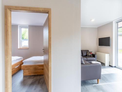 a room with a door leading to a bedroom at Nice bungalow in Hallschlag near the lakebeach in Hallschlag
