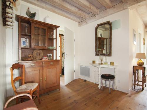 a living room with a table and a mirror at Very nice cottage with studio on a domain with heated pool in Roussines