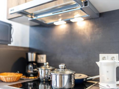 a kitchen counter with pots and pans on a stove at Nice bungalow in Hallschlag near the lakebeach in Hallschlag