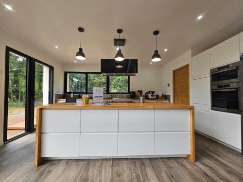 a kitchen with white cabinets and a counter top at Les Quatre Baies in Guichen