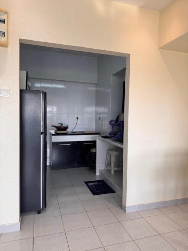 a kitchen with a stainless steel refrigerator in it at Sri Sayang sunset 2 bedroom in Batu Ferringhi