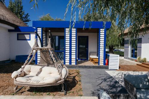 a swinging chair in front of a house at WPO - WILD PIKE OASIS in Caraorman