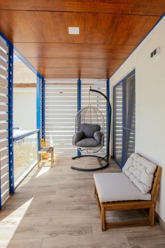 a porch with a chair and a swing at WPO - WILD PIKE OASIS in Caraorman
