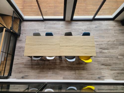 a wooden table with chairs in a room at Les Quatre Baies in Guichen