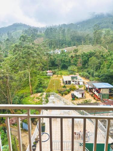 a view of a village from the balcony of a house at Grand adamspeak hotel & restaurant in Adams Peak