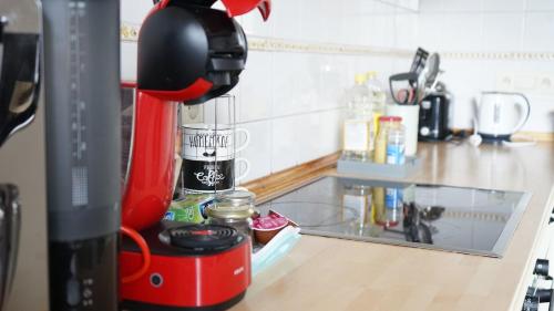 a kitchen counter with a coffee maker on a table at La Maisonnette - 2 chambres, parking, jardinet & calme in Tournai