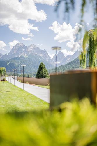 a view of a road with mountains in the background at Alpenwellnesshotel St. Veit in Sesto