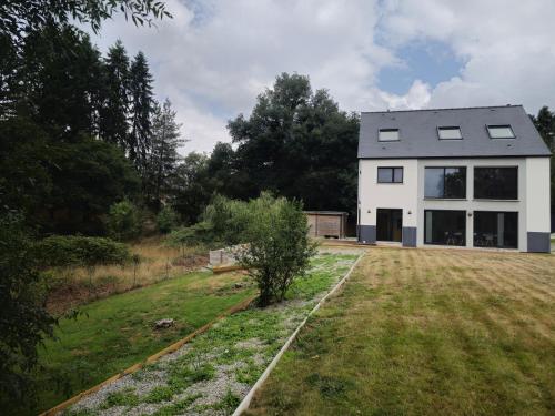 a large white house with a large yard at Les Quatre Baies in Guichen