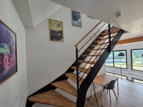 a staircase in a house with wooden floors at Les Quatre Baies in Guichen