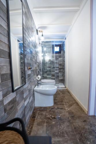 a bathroom with a toilet and a glass shower at Feudo Nobile in Gela