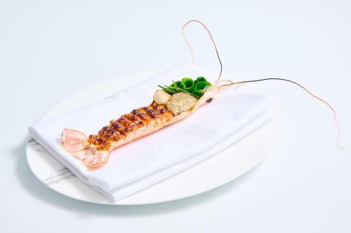 a plate of food with a lobster on it at Waldorf Astoria Amsterdam in Amsterdam