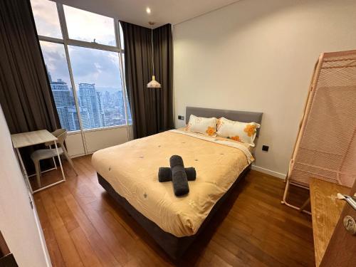 a bedroom with a bed with a teddy bear on it at Sky Suites Home Stay AT kLCC AREA in Kuala Lumpur