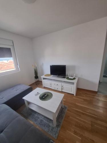 a living room with a couch and a tv at Apartman MBV Vrnjačka Banja in Vrnjačka Banja