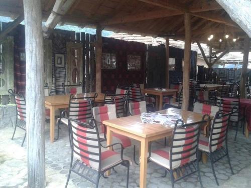 a group of tables and chairs in a restaurant at Etno konačište Protić, Guča in Guča