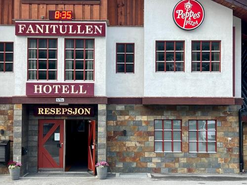 a hotel with a red door and a hotel sign at Fanitullen Hotel in Hemsedal