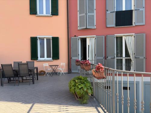 a building with a patio with chairs and a table at Lake Como - Casa Mafy in Bellano