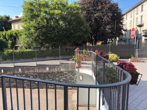 a stairway with a fence and flowers and a stop sign at Lake Como - Casa Mafy in Bellano