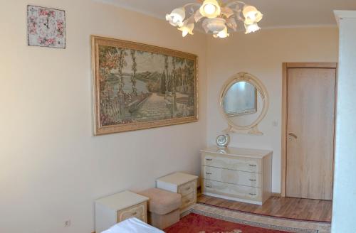 a bedroom with a painting on the wall and a mirror at Europroperties Golden Line in Golden Sands