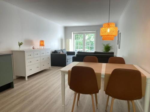 a living room with a dining table and a couch at Langelinie Vin - Countryside in Frederikssund