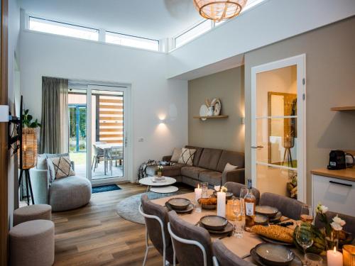 a living room with a table and a couch at Spacious holiday home in Voorhuizen with terrace in Voorthuizen