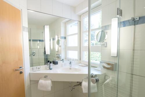 a bathroom with a sink and a mirror at ArtVilla am See - offen März bis Ende Oktober in Radolfzell am Bodensee