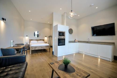 a living room with a bed and a couch and a table at Campbell Street Apartments in Oban
