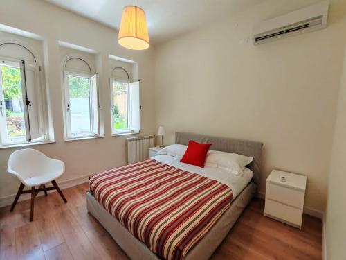 a bedroom with a bed with a red pillow on it at Villa Miami Taormina in Taormina