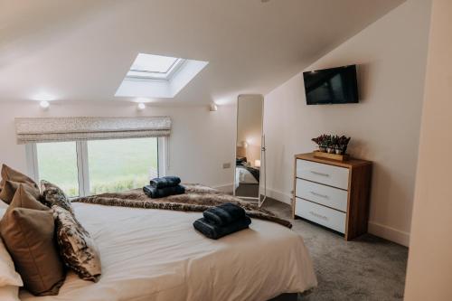 a bedroom with a large bed with a window at A Spacious Countryside Retreat for up to 16 Guests in Llanarthney