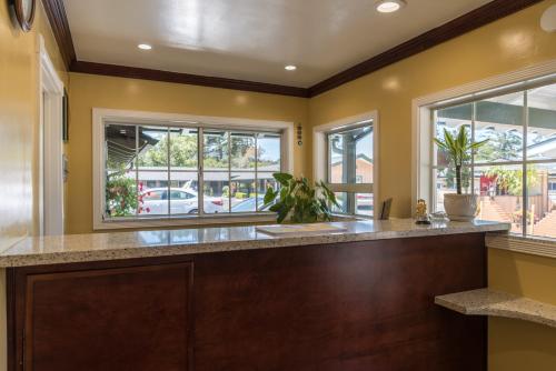 a large kitchen with yellow walls and windows at Padre Oaks in Monterey