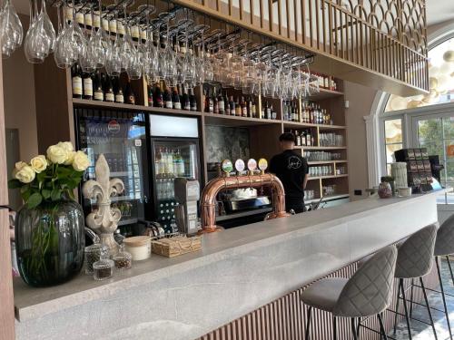 a bar with a counter with wine glasses at Boutique Hotel Balș in Balş