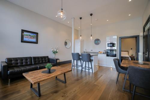a living room with a couch and a table at Campbell Street Apartments in Oban