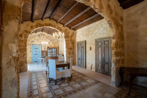 a kitchen and dining room with a table and chairs at Feudo Nobile in Gela