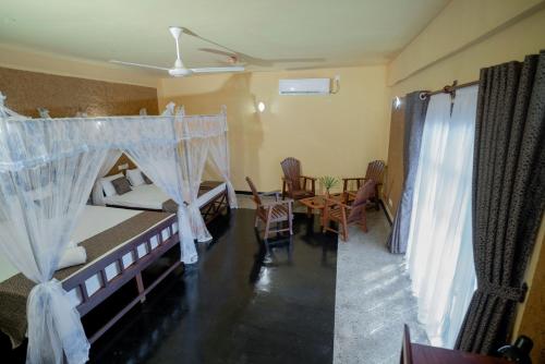 Postel nebo postele na pokoji v ubytování Manikgoda Tea Paradise New