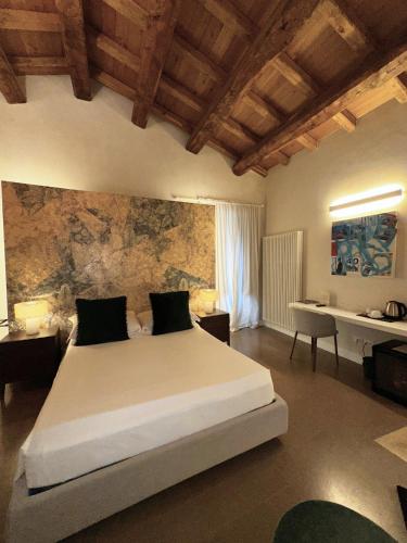 a bedroom with a large bed in a room at Ginevra Boutique Rooms - Palazzo Leosini - Residenze D'Epoca in LʼAquila