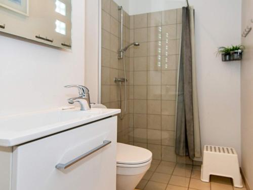 a bathroom with a shower and a toilet and a sink at Norddjurs Holiday Center in Glesborg