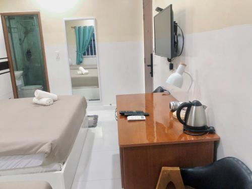 a bedroom with a bed and a desk with a television at SG Cozy House - Self Check In in Ho Chi Minh City