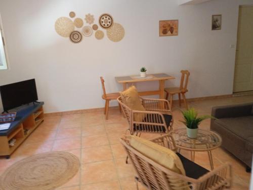 a living room with a couch and a table at Chez Dominique et Jean-Louis - Logement T2 50m2 in Tourves