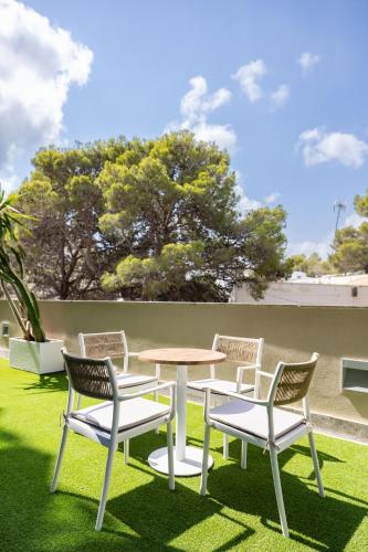a group of chairs and a table on a lawn at Cullera Holiday in Cullera