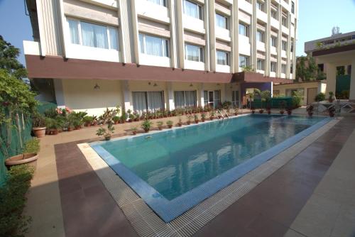 a swimming pool in front of a building at IRA By Orchid Bhubaneswar in Bhubaneshwar