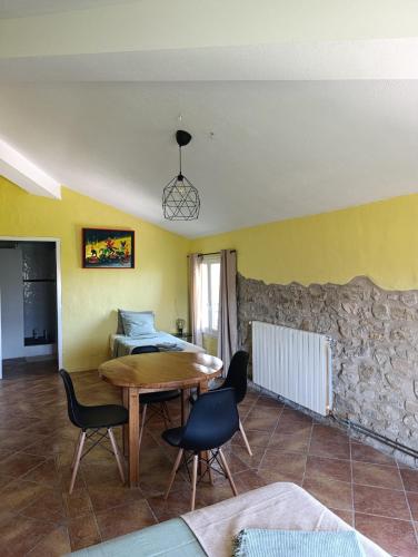 a living room with a wooden table and chairs at Mas Pitre in Besalú