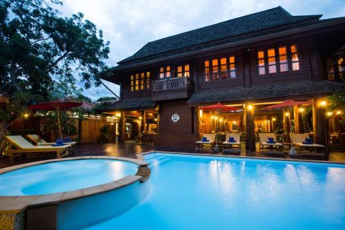 an image of a swimming pool in front of a house at Ruen Come In in Chiang Mai